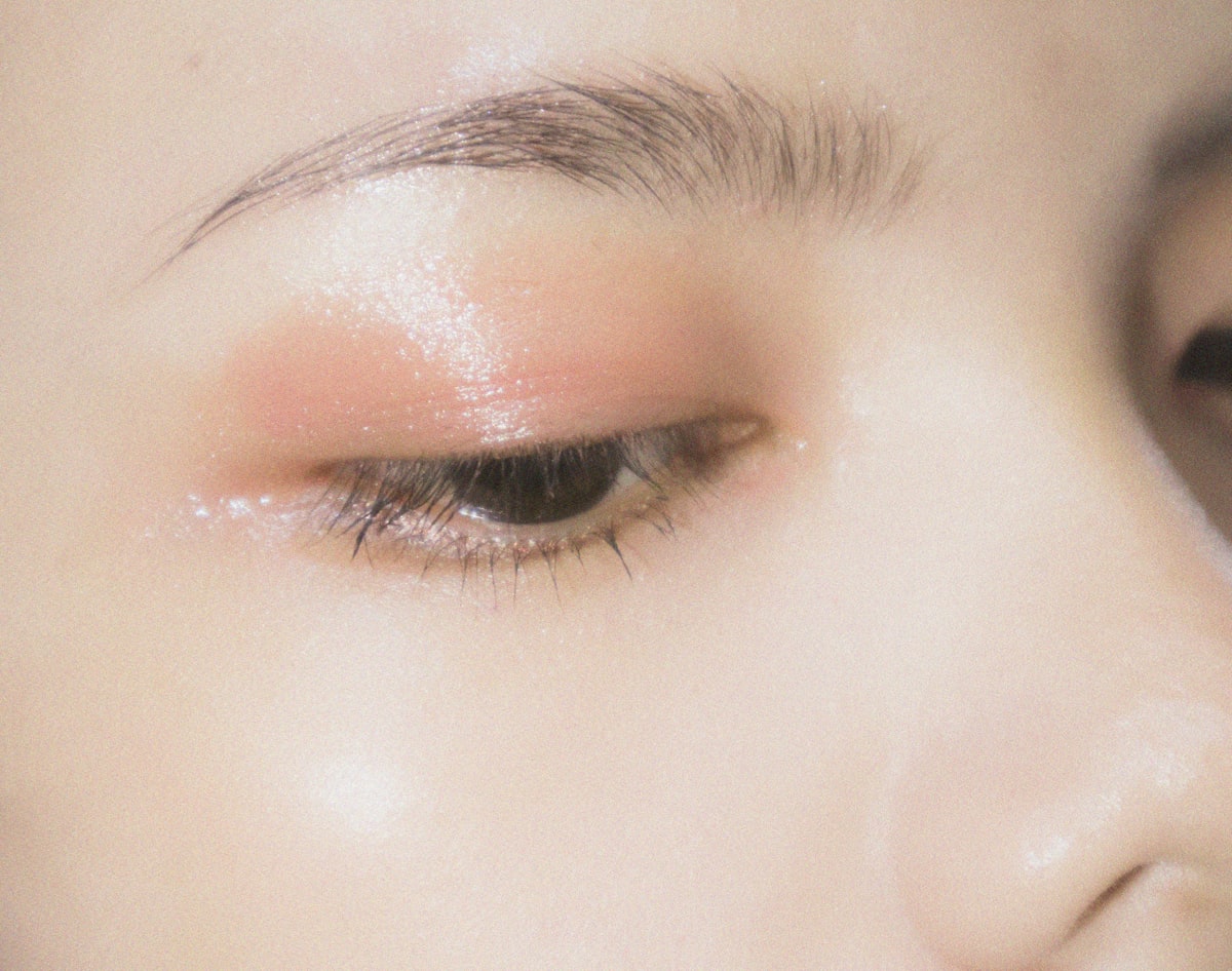 Close-up of refined, glowing skin with soft peach tones